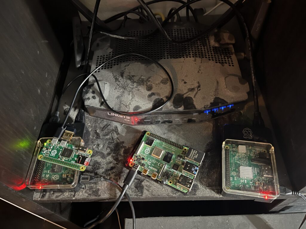 A very dusty shelf/router and my raspberry pi family.